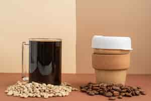 Free photo cup of coffee and coffee beans