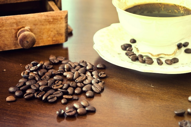 Free photo cup of coffee and coffee seeds