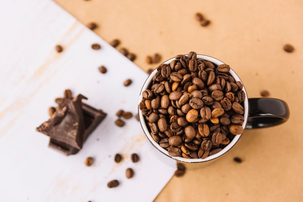 Cup of coffee grains on sheet