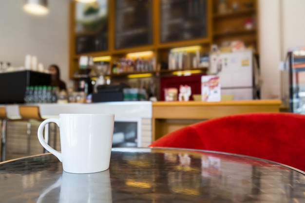 Free photo cup of coffee on metallic table