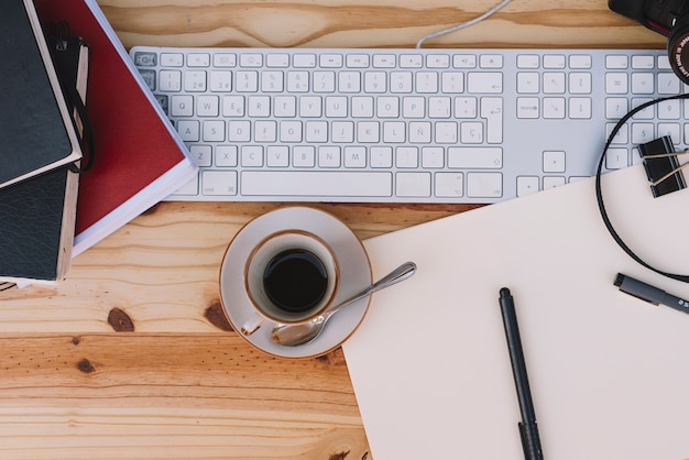 Cup of coffee near keyboard