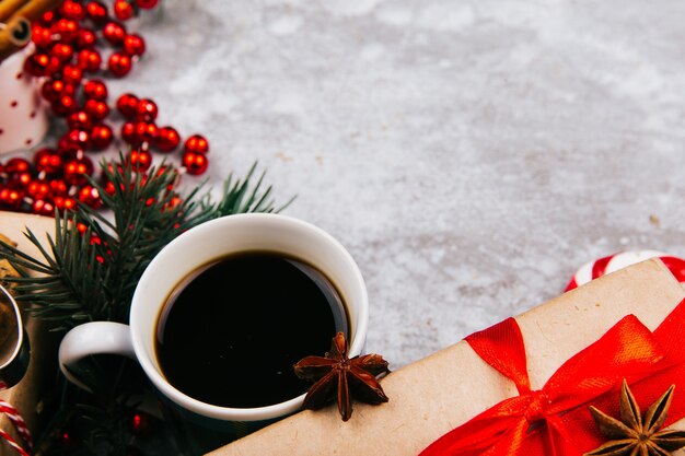 Cup of coffee stands in the circle made of different kinds of Christmas decor