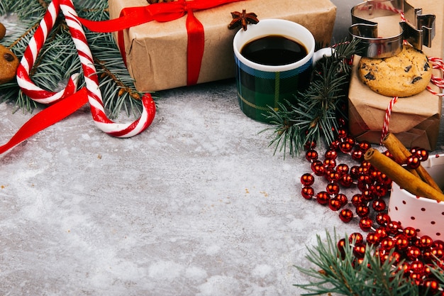 Cup of coffee stands in the circle made of different kinds of Christmas decor