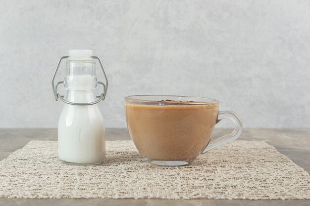 Cup of coffee and sugar on marble table