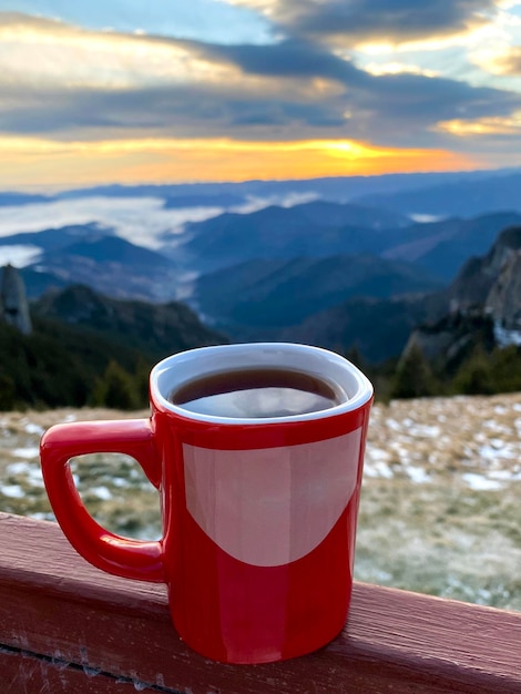 Чашка кофе на пике Тоака в Карпатах на закате Румыния