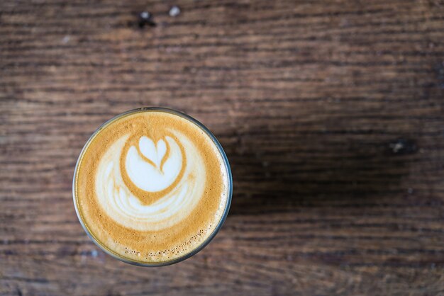 Cup of coffee viewed from above with shapes in the foam