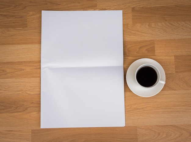 Cup of coffee with blank paper