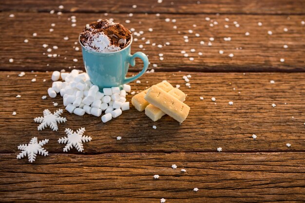 Cup of coffee with cinnamon and fake snow