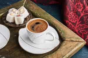 Free photo a cup of coffee with turkish lokum.