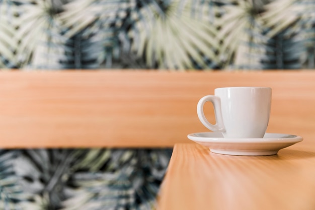 Cup of coffee on wooden desk in caf�