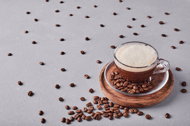 A cup of coffee on a wooden platter.