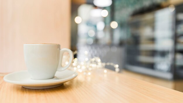 Cup of coffee on wooden table in caf�