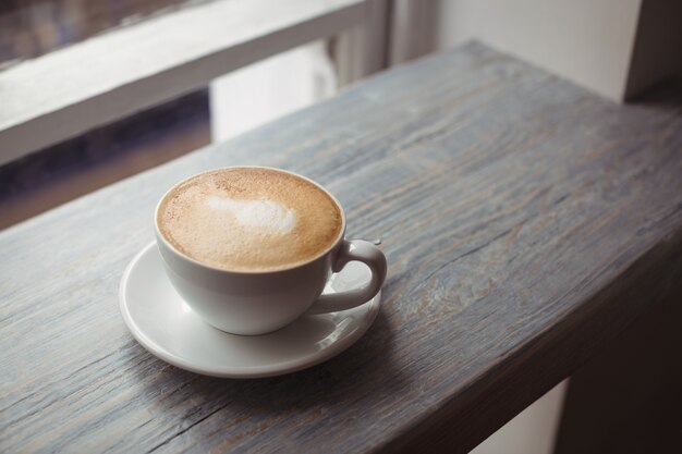 Cup of coffee on wooden table