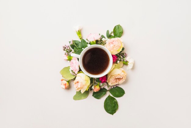 Cup of drink on flower composition