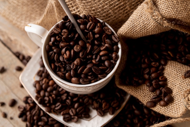 Cup filled with coffee beans close-up