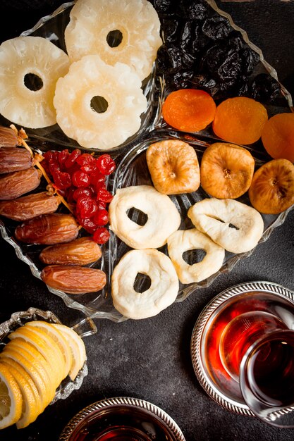 Cup of fragrant tea and a bowl of dried fruit