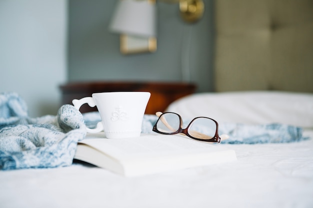 Cup and glasses on book