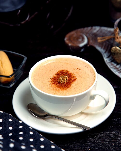 Cup of hot cappuccino with cinnamon