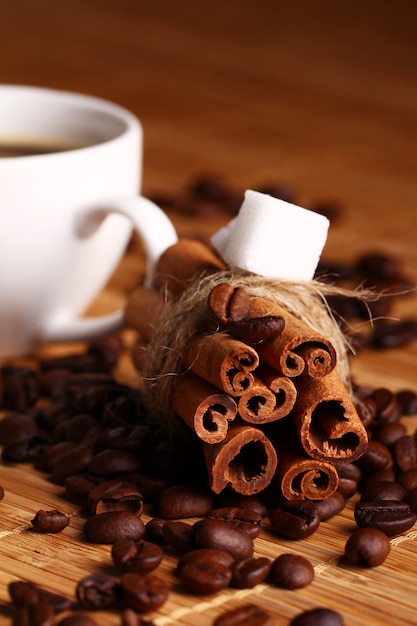 Cup of hot coffee and cinnamon sticks