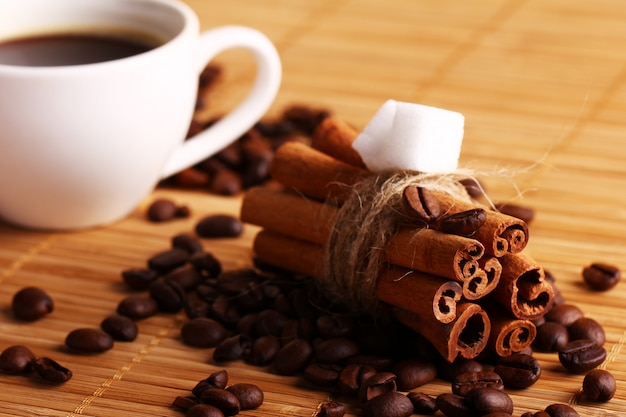 Cup of hot coffee and cinnamon sticks