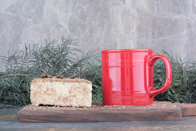 A cup of hot coffee with piece of cake on marble background. High quality photo