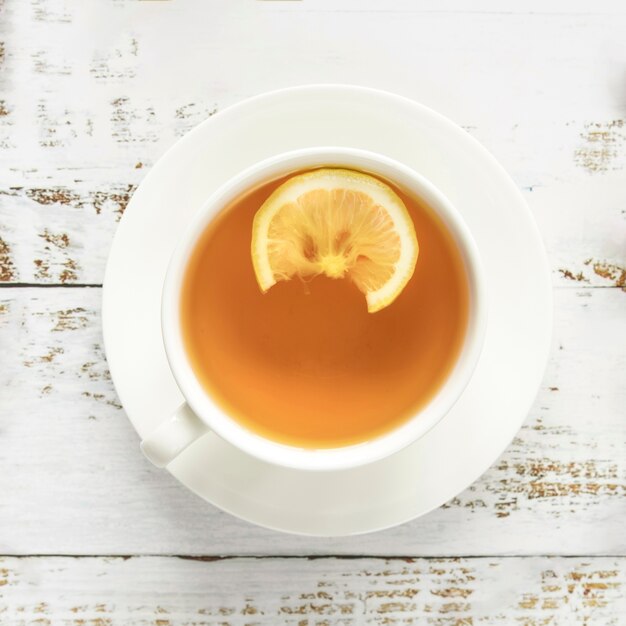 Cup of hot tea on wooden surface