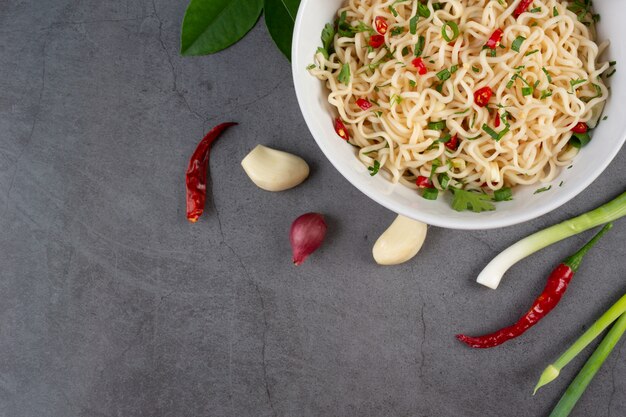 Cup of instant noodle isolate with ingredients and chopsticks