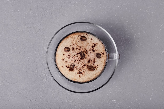 A cup of latte isolated on grey background.