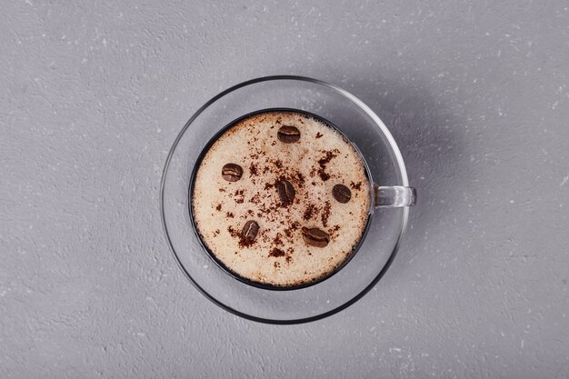 A cup of latte isolated on grey background.