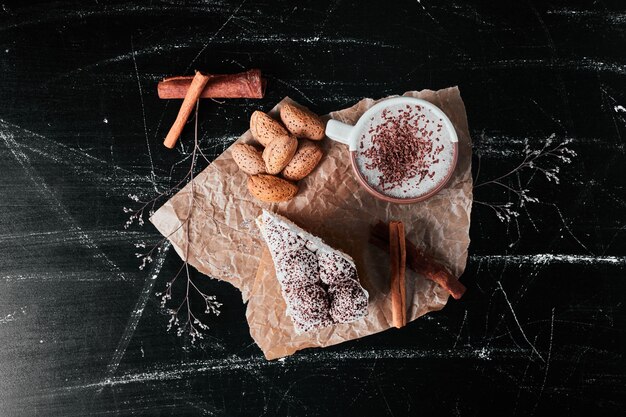 Cup of milk with coffee powder and almonds.