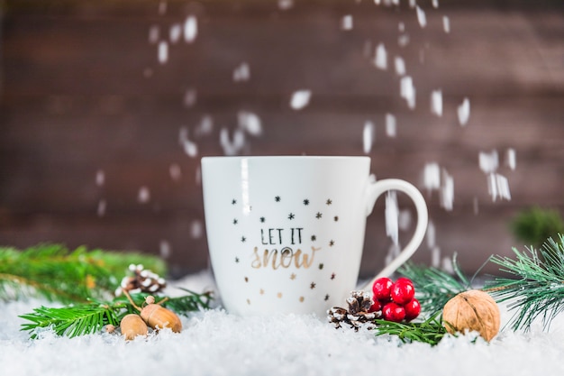 Cup near snags and twigs on snow