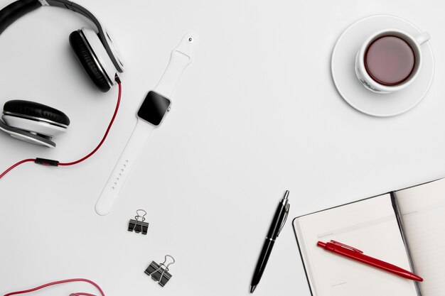 cup, pen, and headphones on white