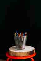 Free photo cup of pencils on stool