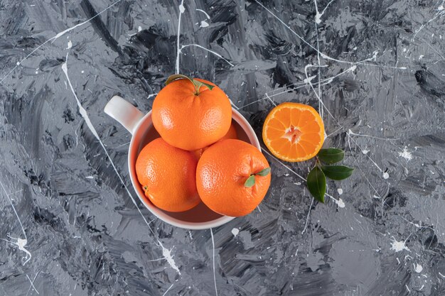 A cup of ripe tangerine , on the mixed table.