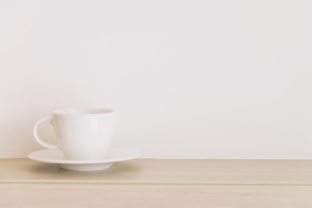 Cup and saucer on wooden table