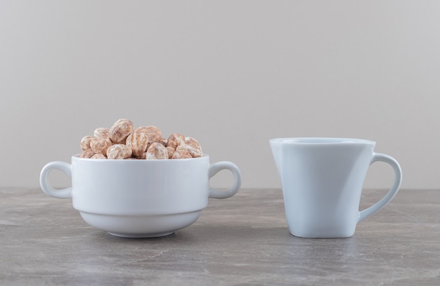 A cup of tea and confectionery on the marble surface