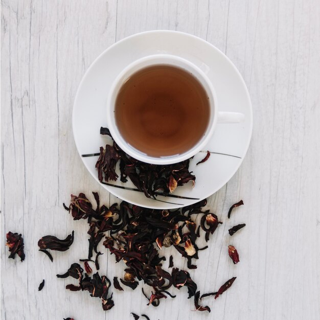 Cup of tea and dried tea leaves