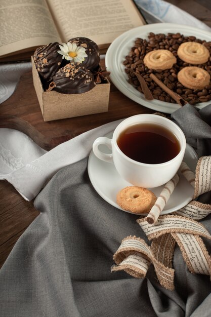 A cup of tea, pralies and cookies