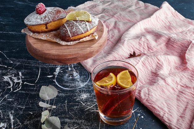 A cup of tea served with chocolate cookies. 