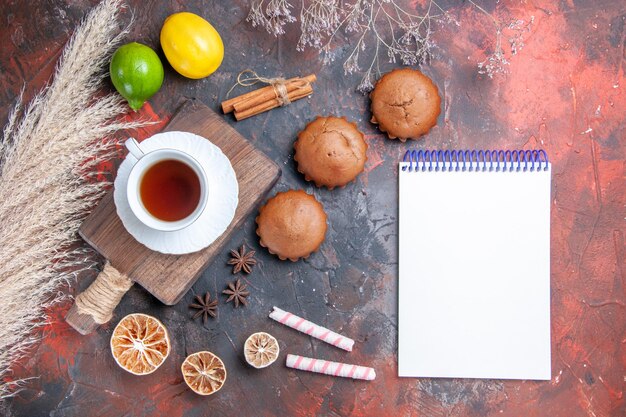 a cup of tea white notebook citrus fruits sweets cinnamon a cup of tea