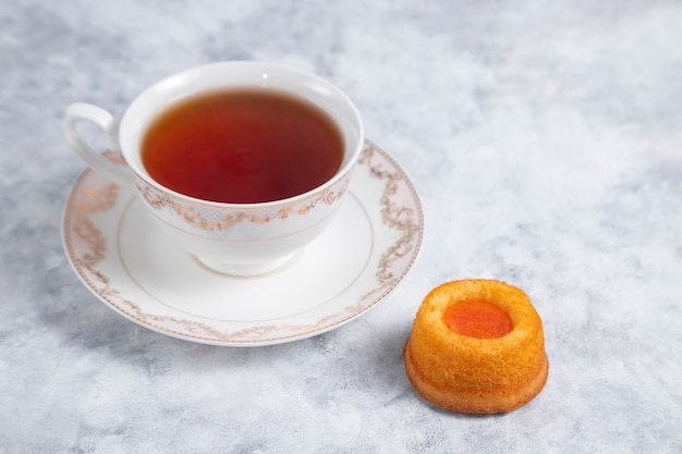 A cup of tea with homemade apricot jam thumbprint cookies.