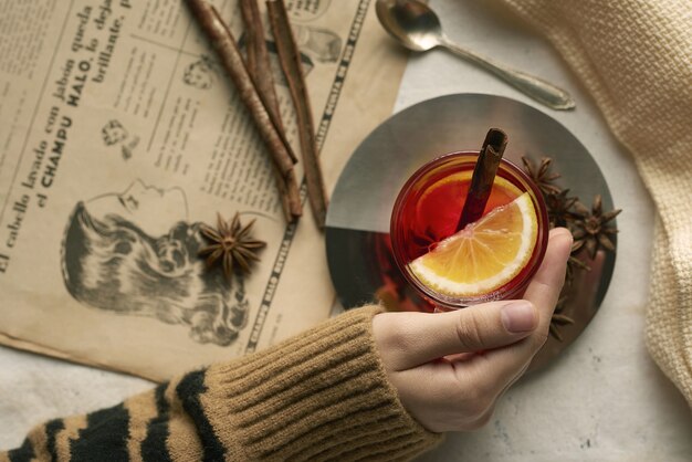 Cup of tea with lemon cinnamon sticks and cloves