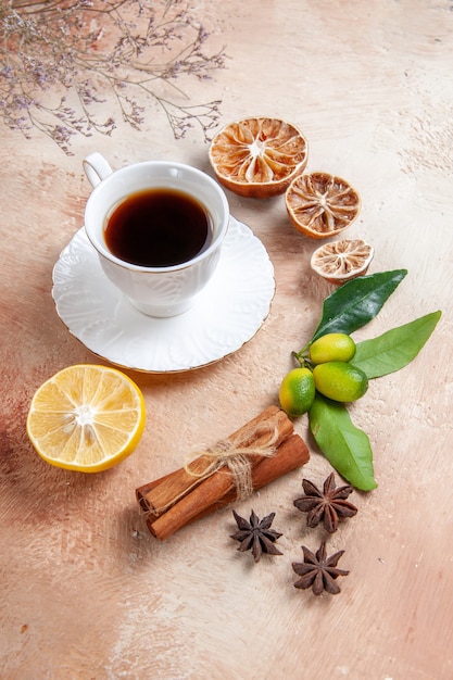 A cup of tea with lemon and cinnamon sticks