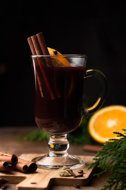 Cup of tea with lemon and cinnamon on wooden board