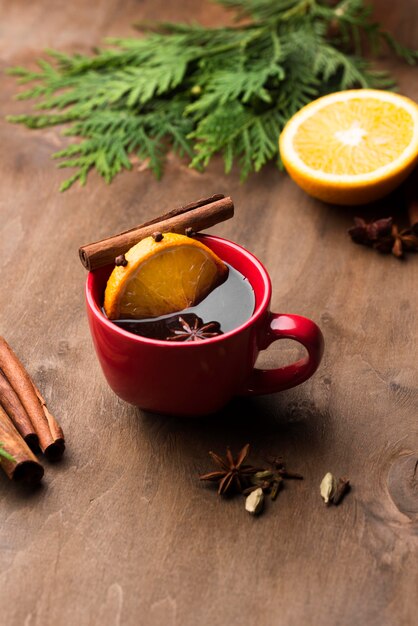 Cup of tea with lemon and fruits on desk