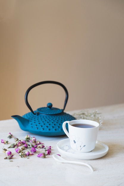 Cup of tea with teapot and breakfast elements