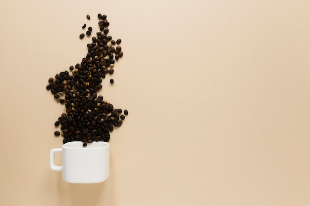 Free photo cup with coffee beans and copy space