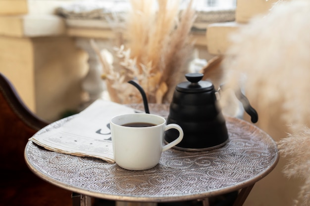 Cup with delicious coffee on table