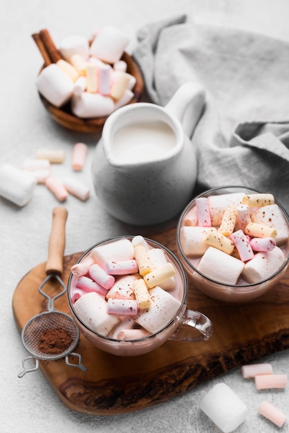 Cup with hot marshmallow drinks on table