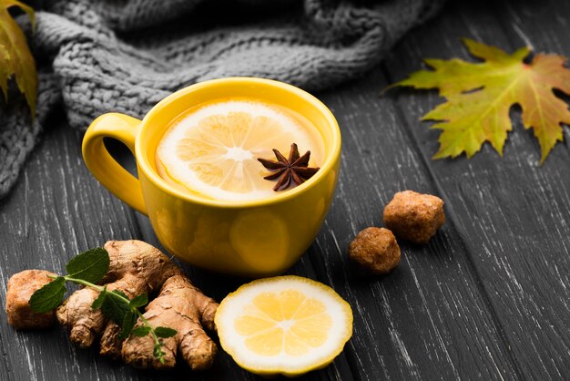 Cup with lemon tea aroma on table